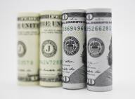 Dollar edges down amid data